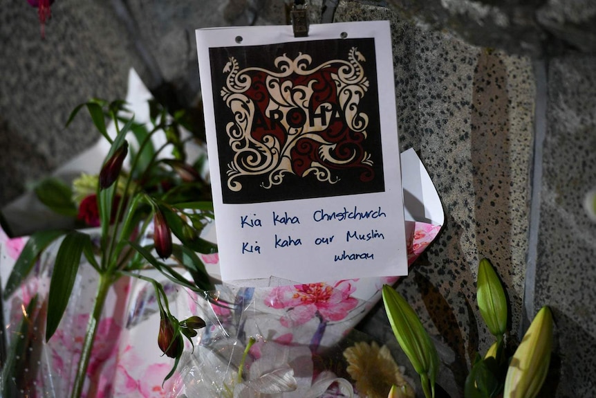 A card saying "Kia kaha Christchurch, Kia kaha our Muslim wharau".