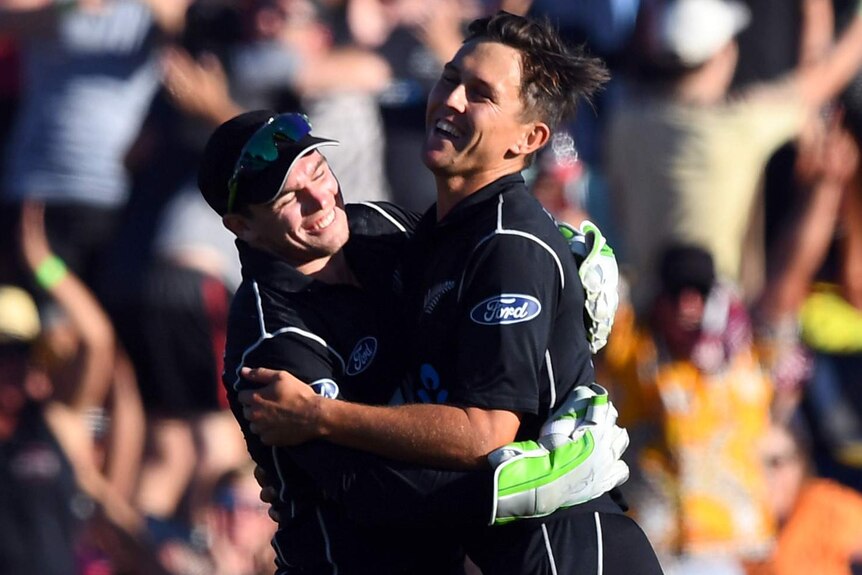 Trent Boult celebrates with Tom Latham