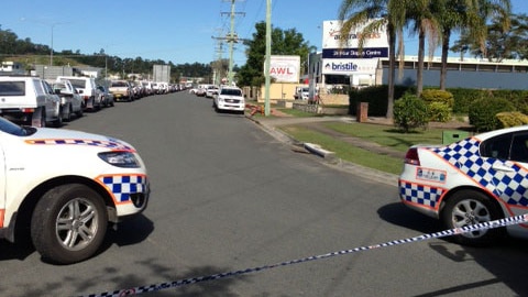 Police cars cordon off street where warehouse has been evacuated at Burleigh on Queensland's Gold Coast