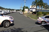 Police cars cordon off street where warehouse has been evacuated at Burleigh on Queensland's Gold Coast