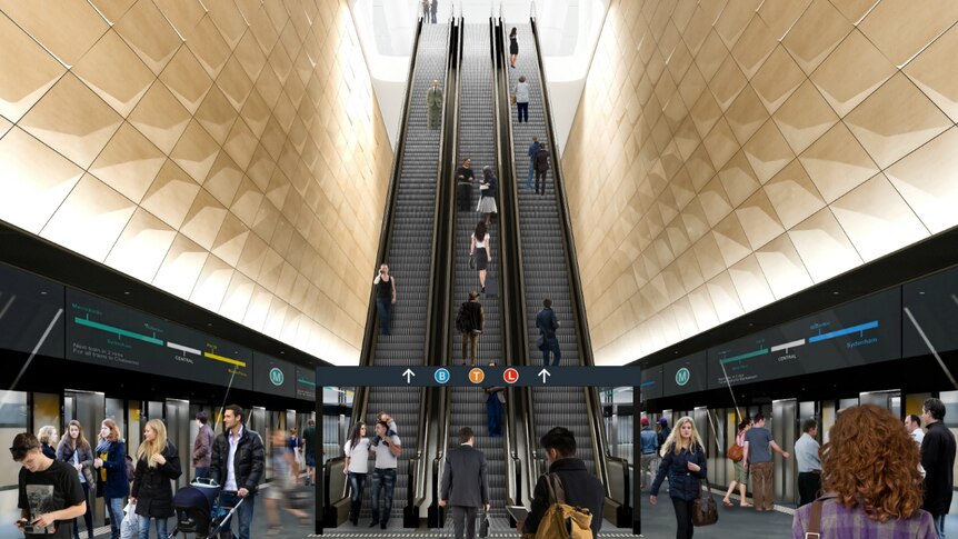 Train commuters going up escalators.