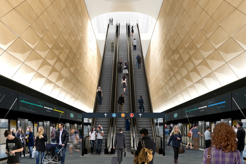 Train commuters going up escalators.