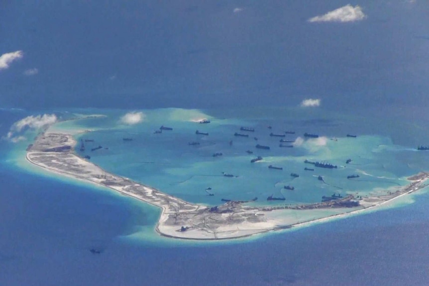 Chinese dredging vessels are seen in the waters around Mischief Reef in the disputed Spratly Islands in the South China Sea