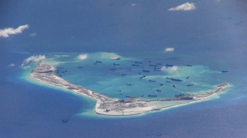 Chinese dredging vessels are seen in the waters around Mischief Reef in the disputed Spratly Islands in the South China Sea