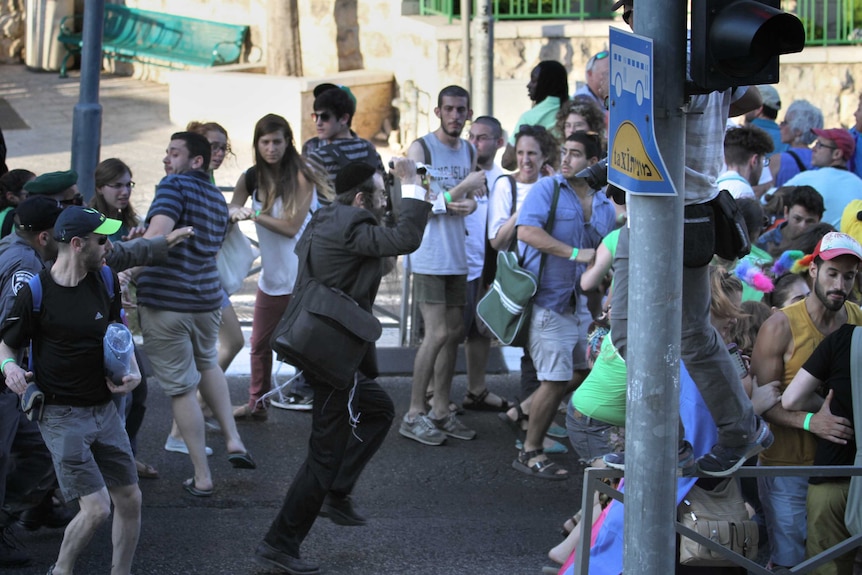 Yishai Shlissel raises a knife at a Gay Pride parade in central Jerusalem