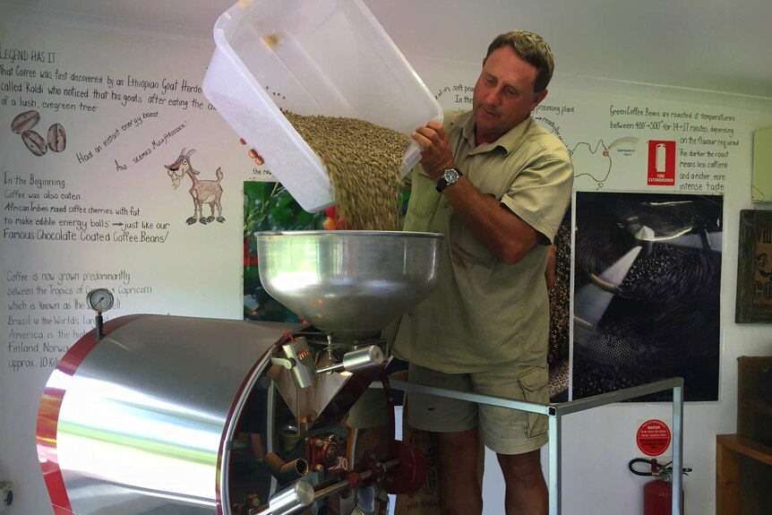 Graham Simpson pours coffee beans