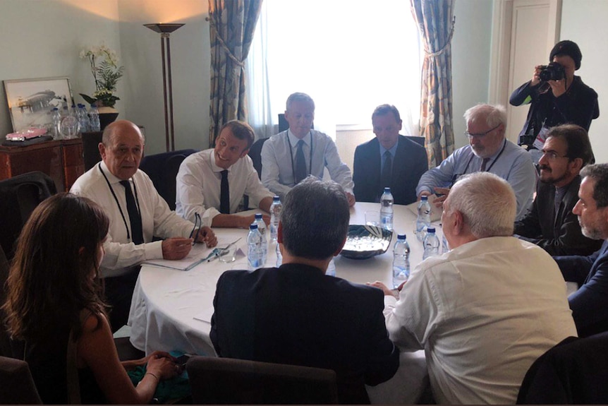 Mohammad Javad Zarif meets with Emmanuel Macron and France's foreign minister after arriving at the G7 summit.