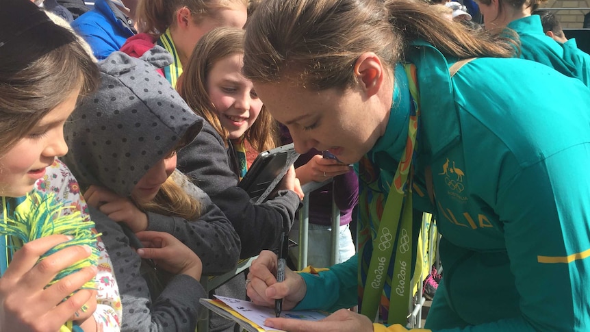 Cate Campbell signs autograph in Hobart