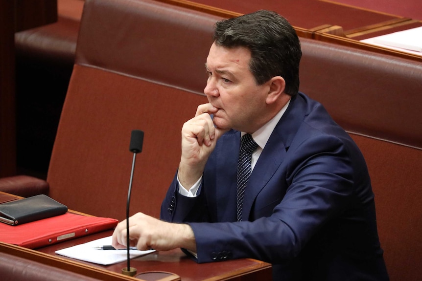 Dean Smith chews his finger, with a nervous expression on his face.