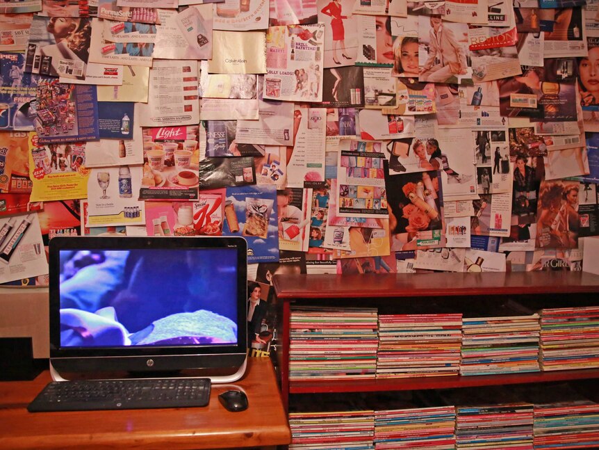 Kara's wall, covered with 1980s and 1990s magazine ads.