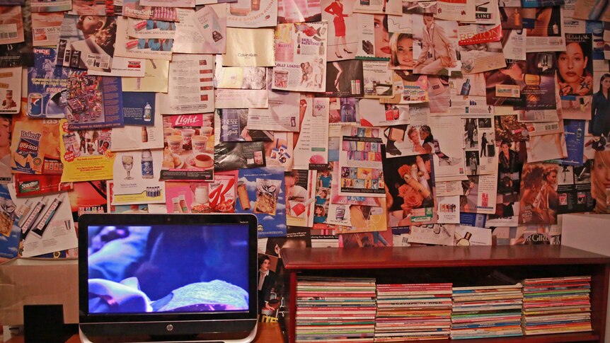 Kara's wall, covered with 1980s and 1990s magazine ads.