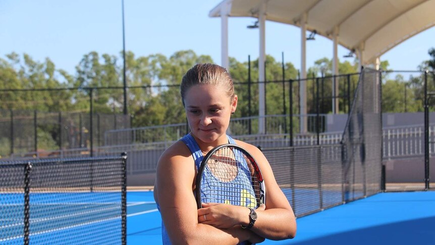 Ashleigh Barty poses with a tennis racket.