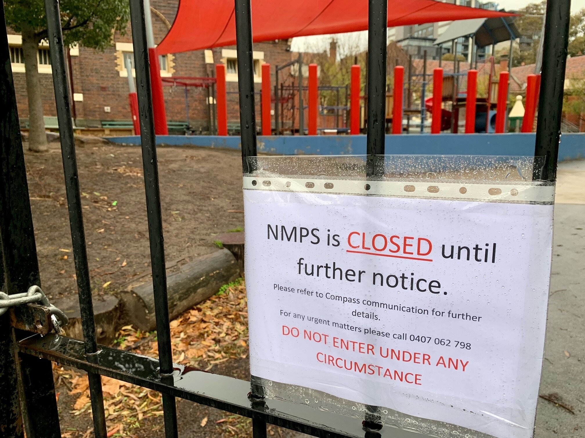 A sign covered in plastic that says NMPS is closed until further notice.