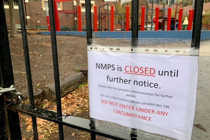 A sign covered in plastic that says NMPS is closed until further notice.