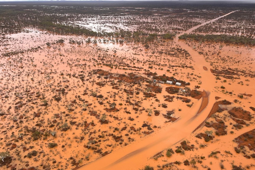 An aerial photo showing muddy water flooding the landscape