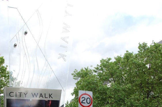 Police car in Canberra city centre with City Walk sign.