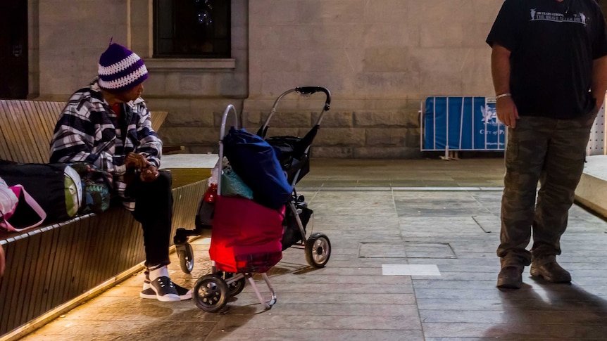 An elderly woman sits on the bench she will sleep on in Perth's CBD.