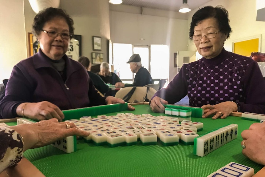 Two ladies playing Mah Jong at Chung Wah aged care