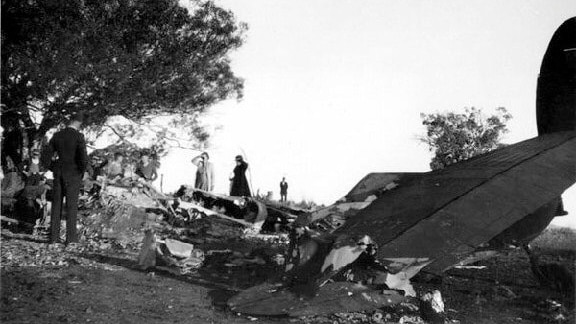 People examine the crash site of the Canberra Air Disaster in 1940 which killed 10 people.