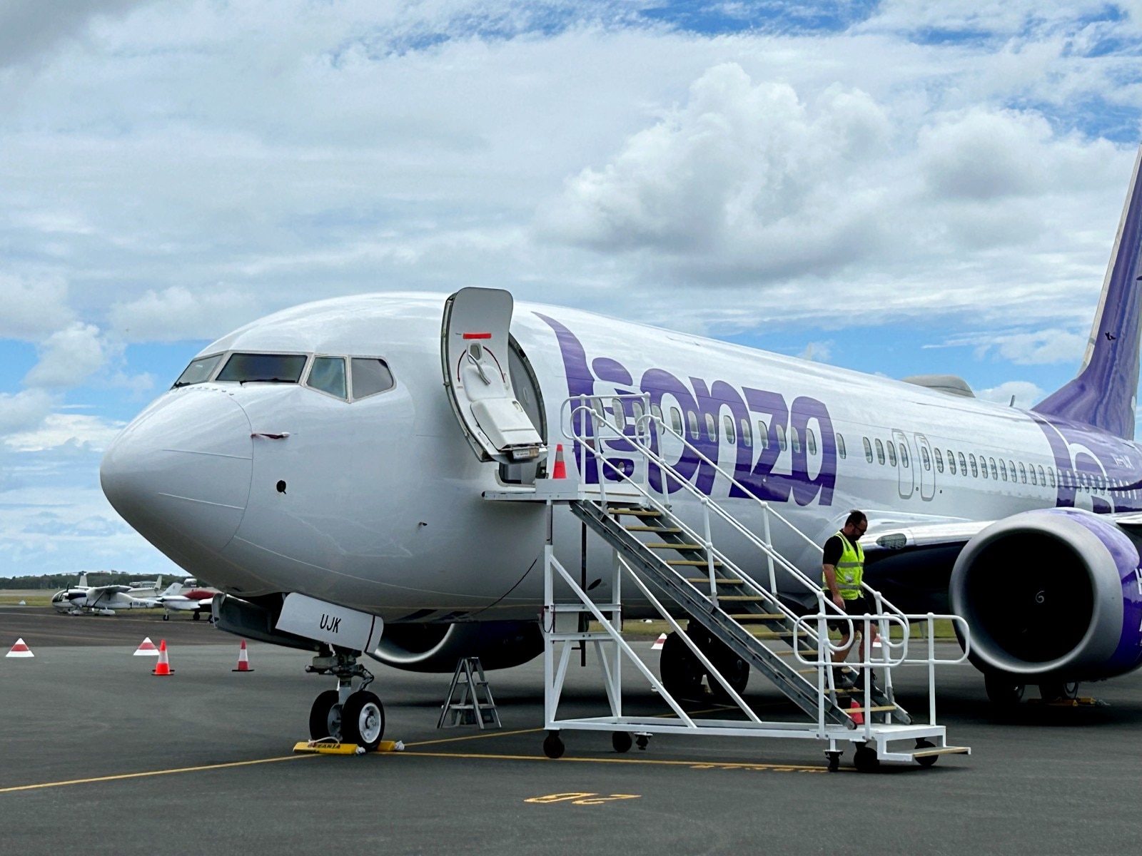 plane on tarmac with man walking down