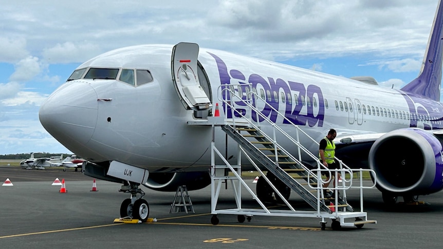 plane on tarmac with man walking down