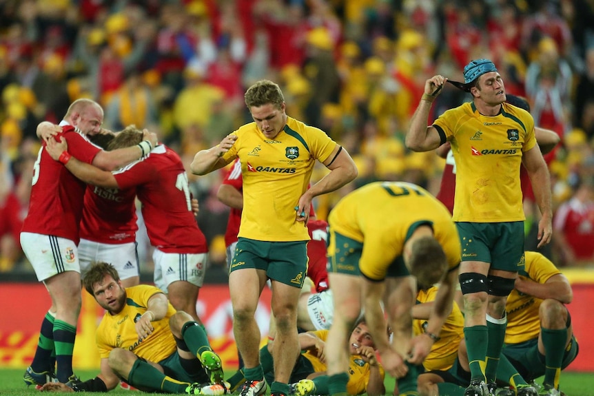 What might of been ... Michael Hooper look dejected, as the Lions celebrate victory