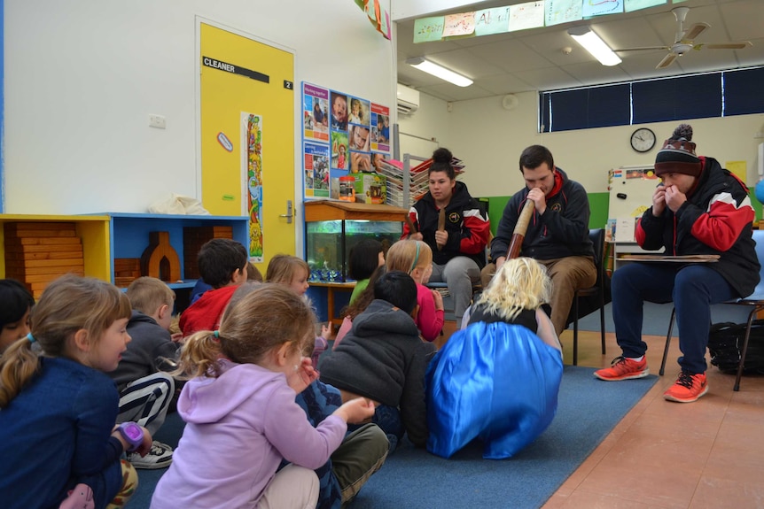 Smith siblings playing instruments at Hawker Primary to a room of preschoolers