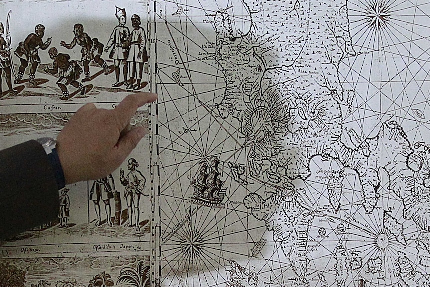 A man points to a 1734 map showing the Scarborough Shoal as part of the Philippine territory.