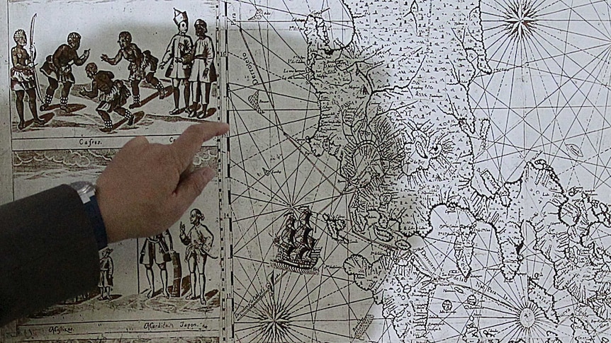 A man points to a 1734 map showing the Scarborough Shoal as part of the Philippine territory.