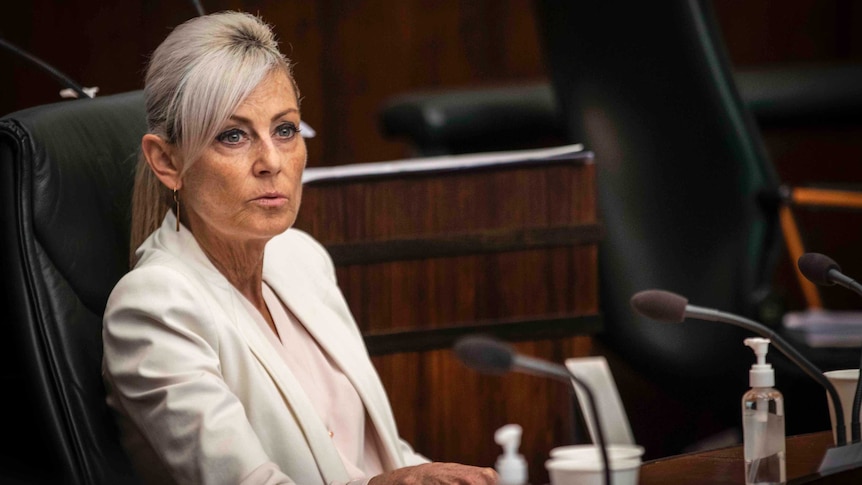 A middle-aged woman sits in parliament