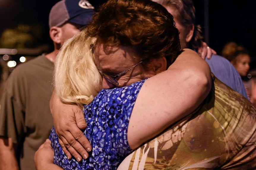 Members of the church embrace during a vigil