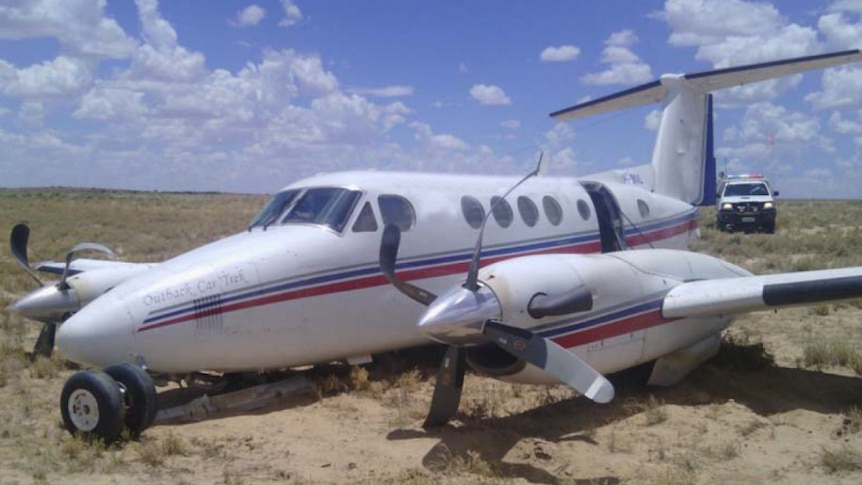 The Royal Flying Doctor Service plane that crash-landed in Moomba, showing bent propellers and damaged landing gear.