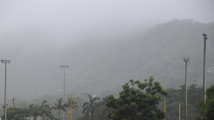 Rain is seen falling on the hillside