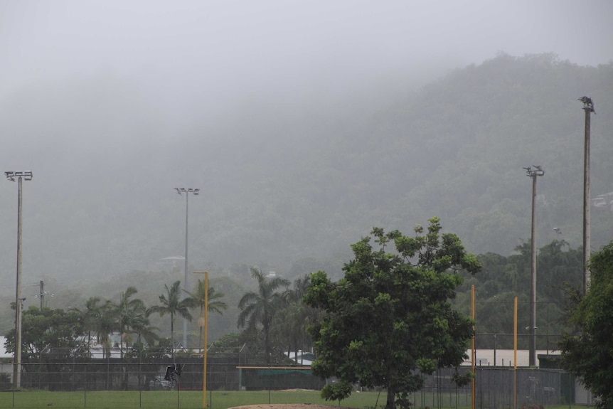 Rain is seen falling on the hillside