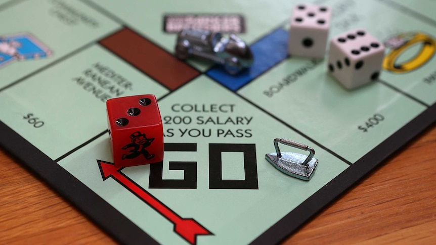 Game pieces on a Monopoly board