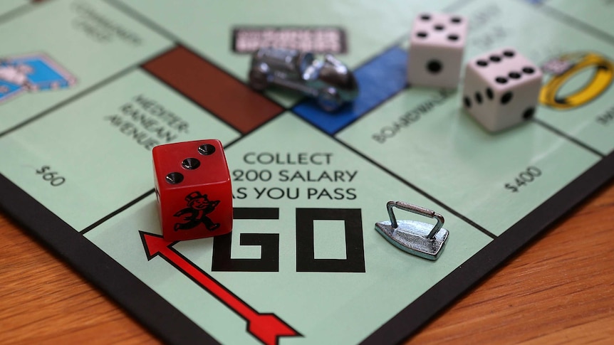 Game pieces on a Monopoly board