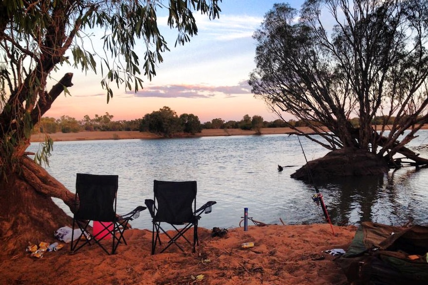 A fishing spot at Yeeda Station with rubbish on the ground next to folding chairs and a fishing rod.