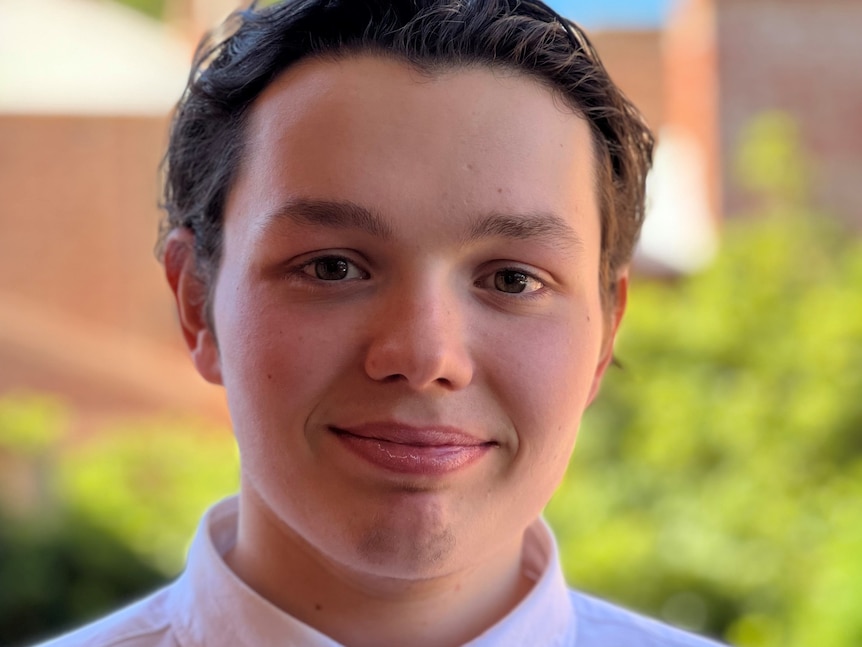 A headshot of a young man with an open face and a pleasant smile.