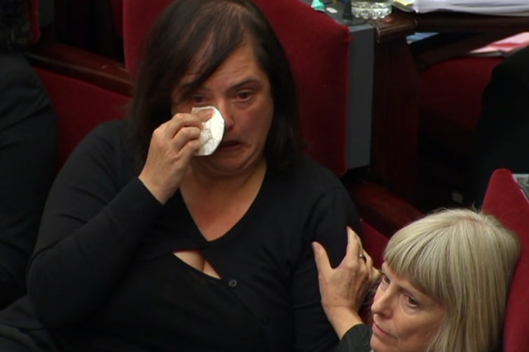 Victorian Greens MP Nina Springle is comforted in parliament on Good Friday, 2018.