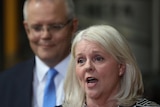 Karen Andrews speaks at a press conference with Scott Morrison standing behind her