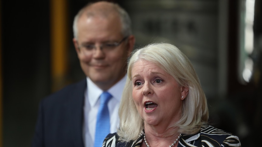 Karen Andrews speaks at a press conference with Scott Morrison standing behind her