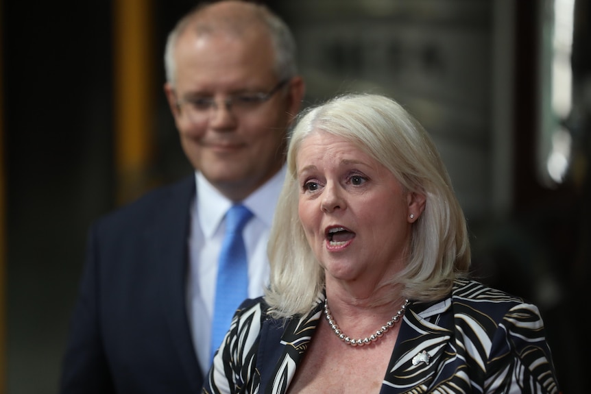 Karen Andrews speaks at a press conference with Scott Morrison standing behind her