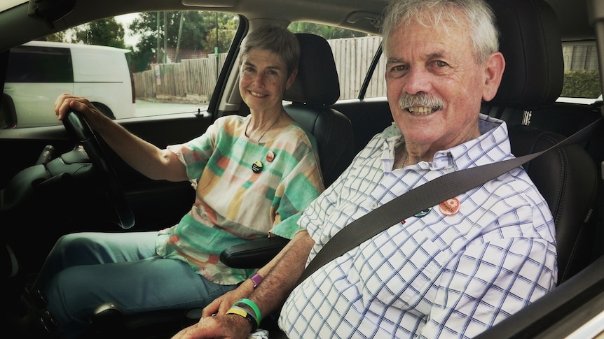 Glenys Petrie behind the wheel with John in the passenger seat.