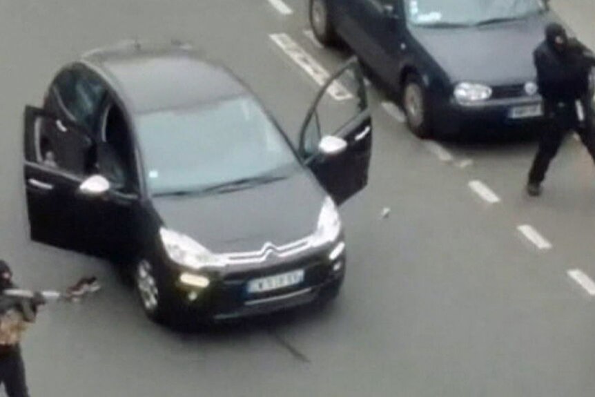 Video still of armed gunmen in Paris street
