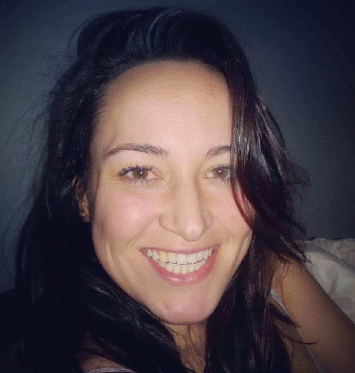 A smiling woman with dark hair.