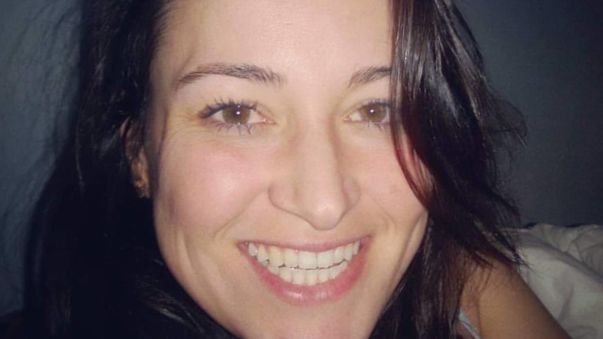 A smiling woman with dark hair.