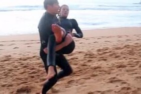Kirra-Belle Olsson is carried from the surf after the shark attack at Avoca Beach
