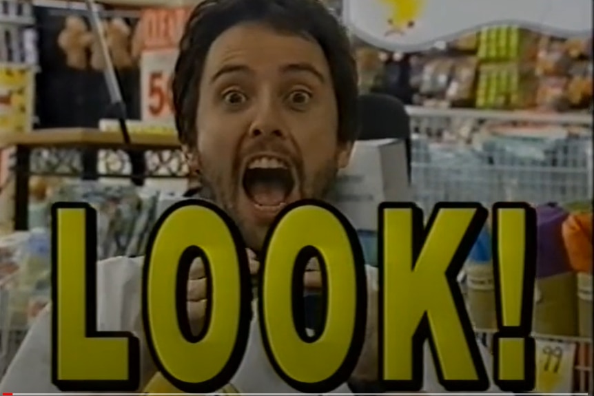 A man with a shocked expression on his face is in a tv ad with the words 'look' on his face