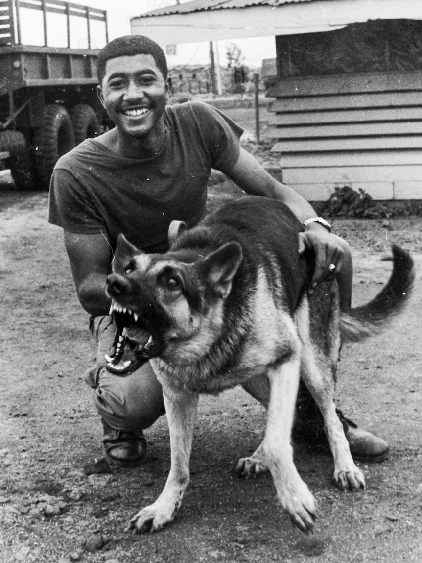 An American soldier with a guard dog.