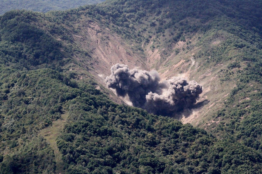 Bombs explode in the hills on the peninsula.